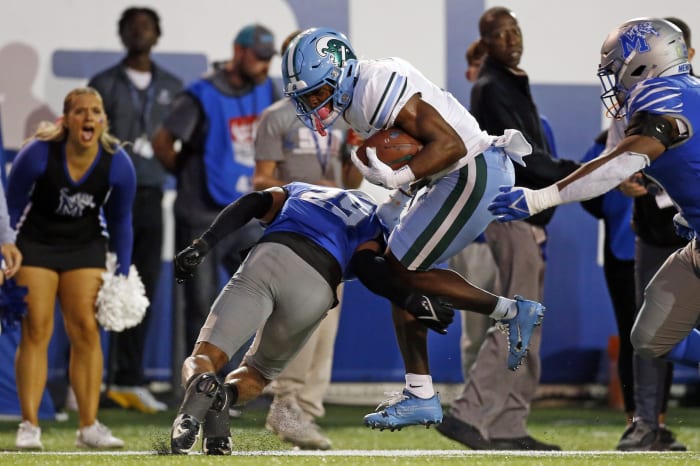 Oct 13, 2023; Memphis, Tennessee, USA; Tulane Green Wave wide receiver Jha'Quan Jackson (4) runs after a catch as Memphis Tigers defensive back Cameron Smith (29) makes the tackle during the first half at Simmons Bank Liberty Stadium. Mandatory Credit: Petre Thomas-USA TODAY Sports